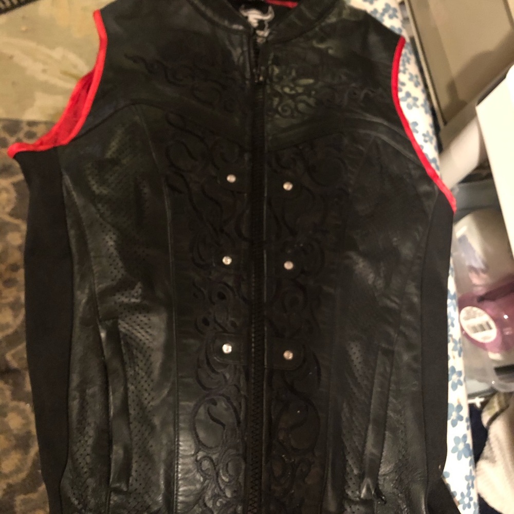 Leather vest with hard shell on inside.